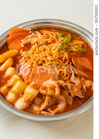 Budae Jjigae or Budaejjigae (Army stew or Army base stew). It is loaded with Kimchi, spam, sausages, ramen noodles and much more 99708901