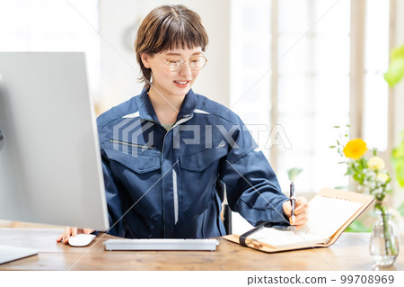 Young female engineer working in design office 99708969