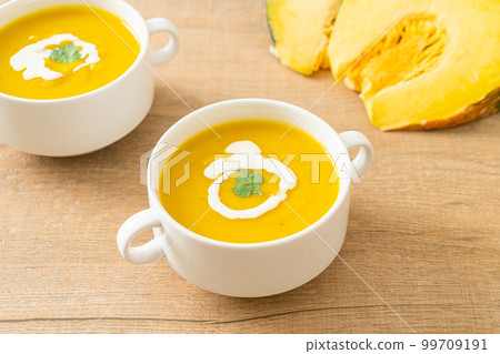 pumpkin soup in white bowl 99709191