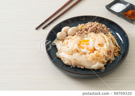 dried spicy noodles with minced pork, meatballs and egg 99709320