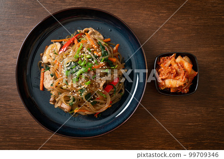 japchae or stir-fried Korean vermicelli noodles with vegetables and pork topped with white sesame 99709346