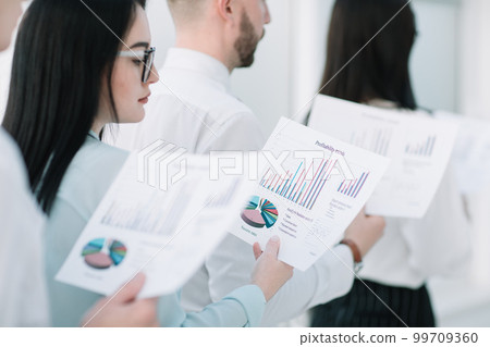 close up.business team with financial data standing in line close up.business team with financial data standing in line 99709360