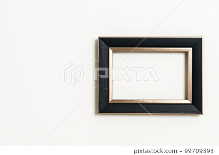empty picture frame on white wall background empty picture frame on white wall background 99709393