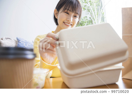 Young woman ordering food delivery 99710020
