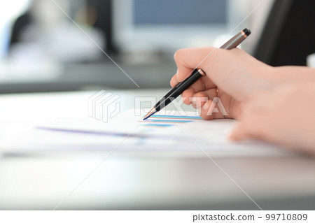 close up. blurred image of a business woman at her Desk 99710809
