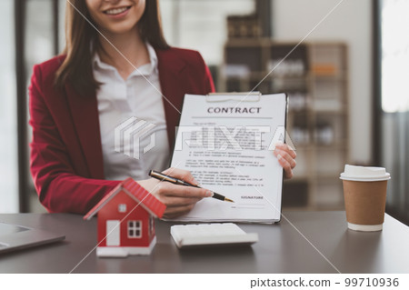 Business person or Real Estate agent explain signing agreement for buying house. Bank manager and real estate concept. Business person or Real Estate agent explain signing agreement for buying house. Bank manager and real estate concept. 99710936
