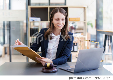 Business Lawyer consulting online on laptop while working at office. 99710946