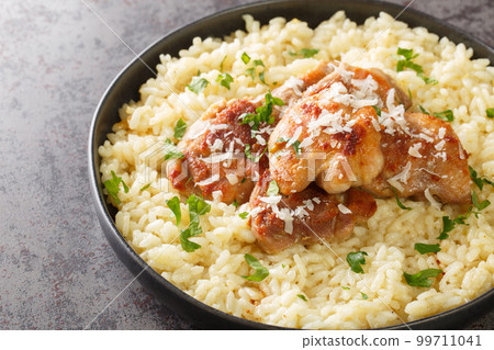 Delicious chicken risotto with parmesan and garlic closeup on the plate. Horizontal 99711041