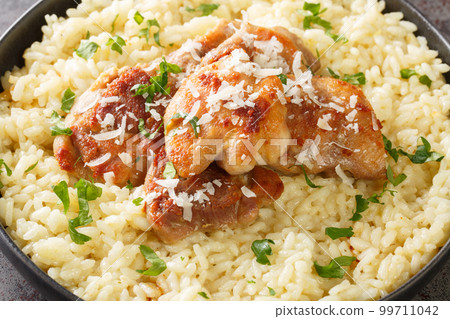 Arborio rice with parmesan and garlic served with fried chicken close-up in a plate. Horizontal 99711042
