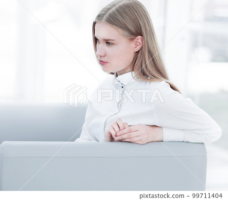 thoughtful young business woman sitting in the lobby of the office 99711404
