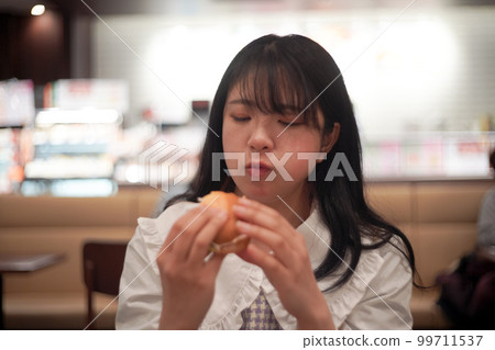 girl chewing bread girl chewing bread 99711537