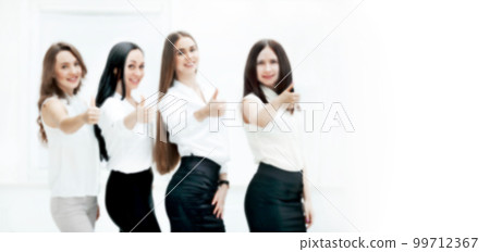blurred image for the advertising text. photo with copy space. triumphant business team holding thumbs up. blurred image for the advertising text. photo with copy space. triumphant business team holding thumbs up. 99712367