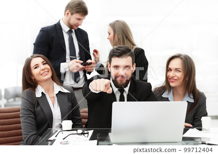 business: professional business team near the workplace with your fingers pointing forward business: professional business team near the workplace with your fingers pointing forward 99712404