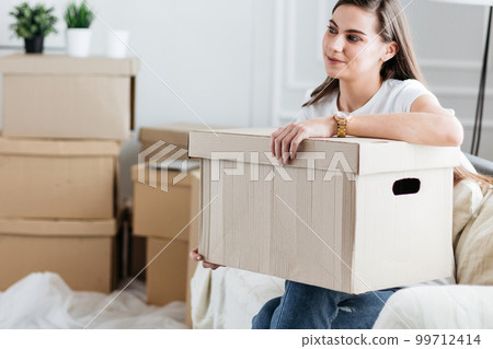 close up. happy young woman with a large cardboard box 99712414