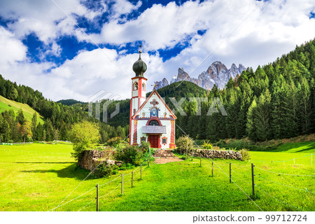 Val di Funes, Italy. Puez Odle in Dolomites and St. John church, South Tyrol landscape. 99712724