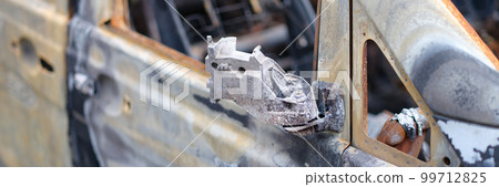 Door of burned-out car on street closeup Door of burned-out car on street closeup 99712825