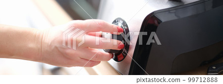 Woman hands switch gears on mixer in kitchen Woman hands switch gears on mixer in kitchen 99712888