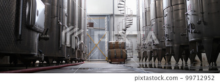 Modern winery interior with large metal tanks 99712952