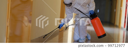 Person in hazmats are cleaned in corridor of hospital or public office Person in hazmats are cleaned in corridor of hospital or public office 99712977