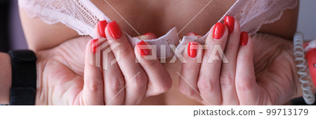 Underwear and beautiful manicured female hands unbutton bra 99713179