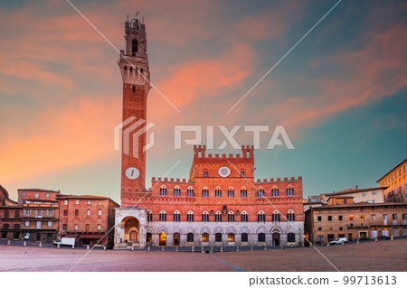 Siena, Italy - Piazza del Campo and the Mangia Tower, morning sunrise. 99713613