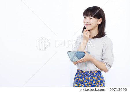 A woman in her thirties with a wallet A woman in her thirties with a wallet 99713690