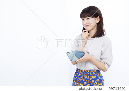 A woman in her thirties with a wallet A woman in her thirties with a wallet 99713691
