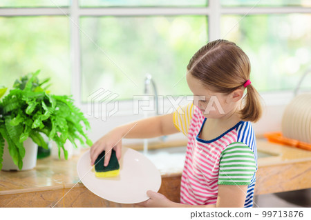 Child washing dishes. Child washing dishes. 99713876