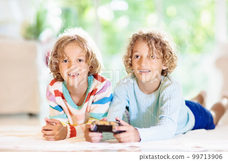 Kids play video game. Children with controller. 99713906