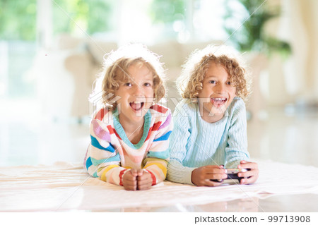 Kids play video game. Children with controller. 99713908
