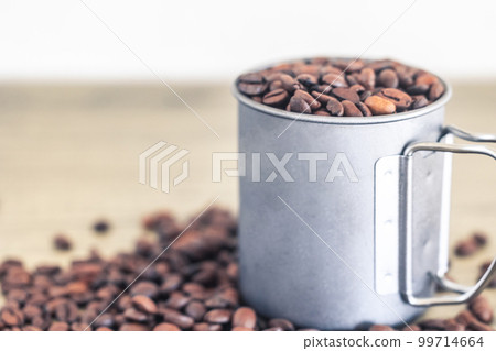 roasted coffee beans and mug 99714664