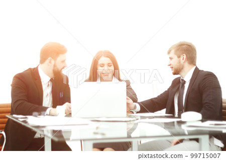 business team sitting at the Desk and discussing current issues 99715007