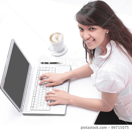 young employee sitting in front of an open laptop. young employee sitting in front of an open laptop. 99715075