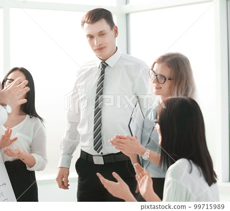 business team applauding after a successful business presentatio business team applauding after a successful business presentatio 99715989