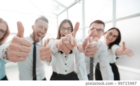 close up. happy business team showing thumbs up. close up. happy business team showing thumbs up. 99715997