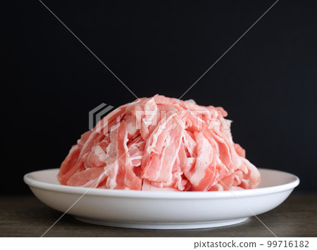 Piles of pork belly slices black background 99716182
