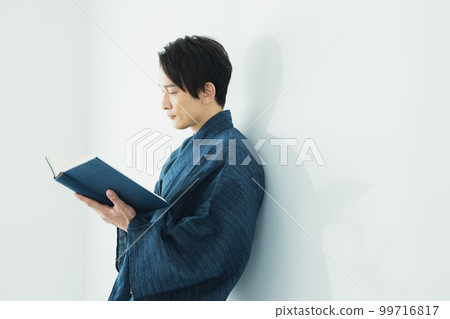 A man in a yukata reading A man in a yukata reading 99716817