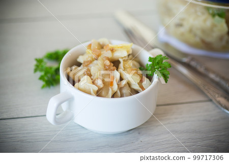 cooked dumplings with potatoes and fried onions on a wooden table. 99717306