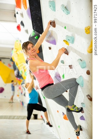 Woman exercising in climbing gym 99717425