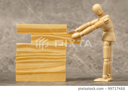 Dummy pulling out wood block from a tower 99717488
