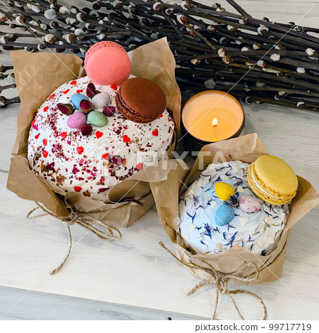 Two beautiful eastercakes decorated with colored chocolate eggs and macaroons Two beautiful eastercakes decorated with colored chocolate eggs and macaroons 99717719