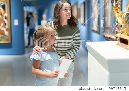 Mother and daughter exploring expositions in museum Mother and daughter exploring expositions in museum 99717845