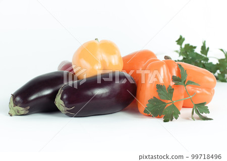 bell pepper,eggplants and sprigs of parsley on a white background. bell pepper,eggplants and sprigs of parsley on a white background. 99718496