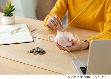 Saving money investment for future. Female woman hands holding pink piggy bank and putting money coin. Saving investment budget business wealth retirement financial money banking concept 99719332
