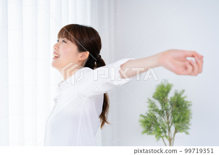 A woman basking in the morning sun A woman basking in the morning sun 99719351