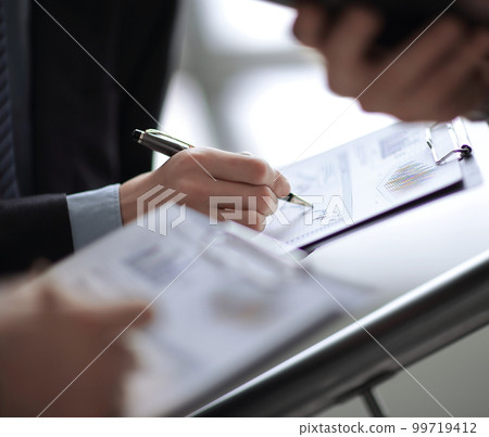 Close up of business people hands pointing growing financial business graph 99719412