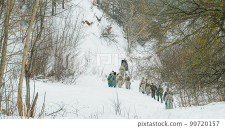 Men Dressed As White Guard Soldiers Of Imperial Russian Army In Russian Civil War s Marching Through Snowy Winter Forest. Historical Reenactment Men Dressed As White Guard Soldiers Of Imperial Russian Army In Russian Civil War s Marching Through Snowy Winter Forest. Historical Reenactment 99720157