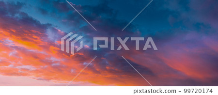 Amazing Sunset Sky With Saturated Colorful Clouds. Scenic View Dramatic Sky. Sun Shining With Sun Rays. Orange Red Clouds Sky. Amazing Sunset Sky With Saturated Colorful Clouds. Scenic View Dramatic Sky. Sun Shining With Sun Rays. Orange Red Clouds Sky. 99720174