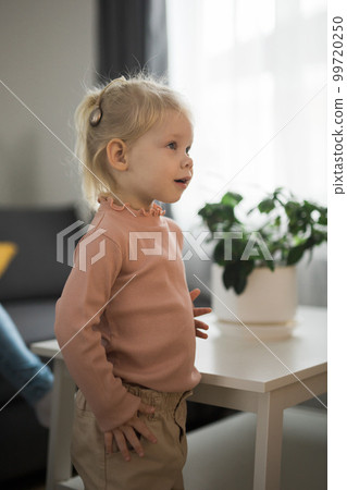 Cochlear implant system. Installation cochlear implant on child girl ear for restores hearing. Kid hears after hear return to normal 99720250