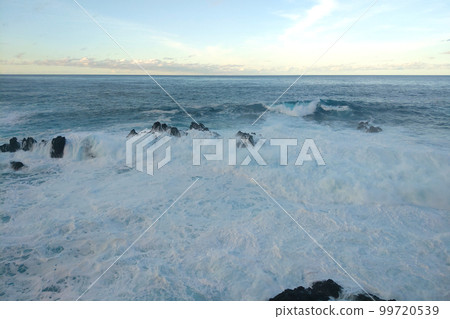 The waves crash against rocks in the ocean. The background of nature. The waves crash against rocks in the ocean. The background of nature. 99720539